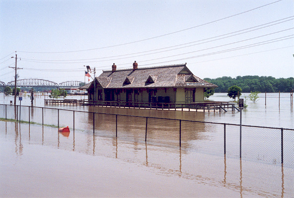 Photo of the Missouri River flooding the railroad station at St. Charles, Missouri.